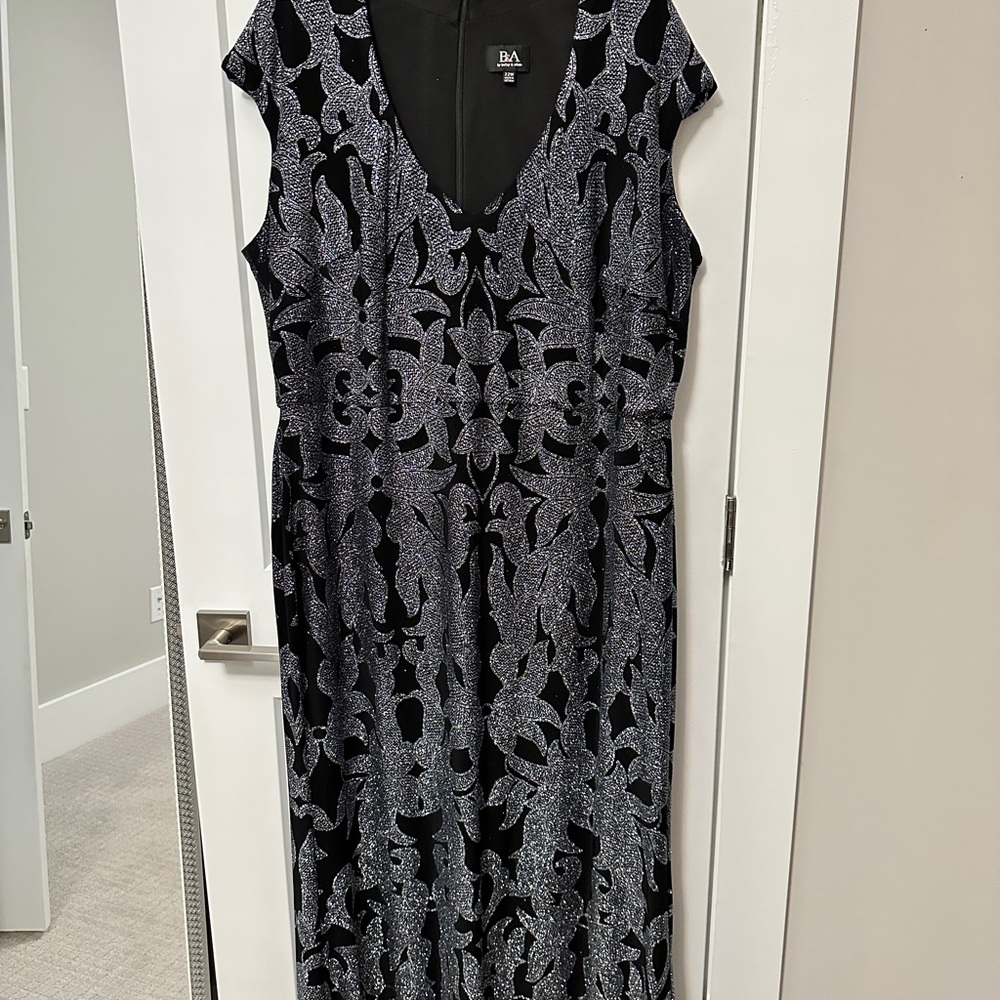 Stunning a full length evening gown. Black with silver printed design.